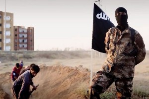 isis-soldier-posing-in-front-of-people-digging-their-own-graves