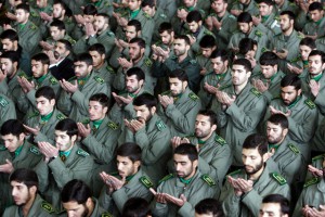 25 Nov 2005, TEHRAN, Iran --- Iranian revolutionary guard corps pray during Friday prayers in Tehran November 25, 2005. Influential Iranian cleric Rafsanjani said on Friday the U.N. nuclear watchdogs latest statement on Iran's disputed atomic programme was a step in the right direction but still contained elements of "harrassment". --- Image by © RAHEB HOMAVANDI/Reuters/Corbis