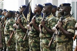 Ivorian army chief General Philippe Mangou (L) reviews his soldiers during a ceremony marking the start of the deployment of government forces in areas controlled by former rebels, at the army's headquarters in Abidjan May 5, 2009. A total of 4,000 government soldiers and an equal number of former rebels will be deployed across the country to provide security for the electoral process, army chief General Philippe Mangou said on Tuesday. Ivory Coast, the world's top cocoa producer, will hold its long-delayed presidential elections by December 6 at the latest, the West African country's U.N. ambassador said last week. REUTERS/Luc Gnago   (IVORY COAST POLITICS MILITARY ELECTIONS)