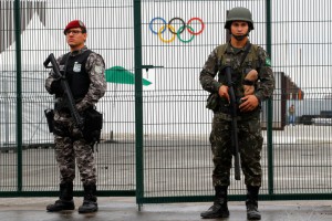 Brazilian Public-Safety National Force (L) and military police soldiers guard an entrance at the security fence outside the 2016 Rio Olympics Park in Rio de Janeiro, Brazil, July 21, 2016.    REUTERS/Fabrizio Bensch