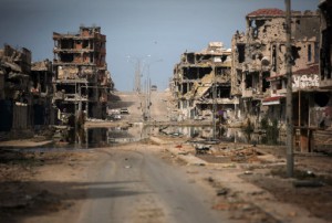 FILE - In this Saturday, Oct. 22, 2011 file photo, a general view of buildings ravaged by fighting in Sirte, Libya. A leading international rights group on Wednesday released a report documenting atrocities committed by Libya's Islamic State affiliate in the country's coastal city of Sirte, a stronghold of the militants. (AP Photo/Manu Brabo, File)