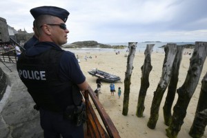 French anti-riot policemen (CRS - compagnie Republicaine de Securite) patrol close to the beach of Saint-Malo, western France on July 21, 2016.nFrench lawmakers voted massively on July 20, 2016, to extend a state of emergency as President Francois Hollande said that a call to boost reserve forces had paved the way towards a "National Guard." The government is scrambling to find new ways to assure a jittery population after its third major attack in 18 months saw a truck driver plough into a crowd celebrating Bastille Day in Nice, killing 84 people.n / AFP / DAMIEN MEYER        (Photo credit should read DAMIEN MEYER/AFP/Getty Images)