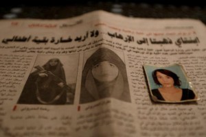 Photographs of Rahma (L and passport photo), the wife of Noureddine Chouchane, who was killed during a U.S. air strike in Libya, and her sister Ghofran (R, on newspaper), are seen in Tunis, Tunisia April 14, 2016. REUTERS/Zohra Bensemra/File Photo