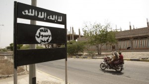 FILE - In this Friday, June 15, 2012 file photo, an al-Qaida logo is seen on a street sign in the town of Jaar in southern Abyan province, Yemen. Arabic on the logo reads, "There is no god but God," and "Muhammad is the messenger of God."Under a heavy fog, al-Qaida militants disguised in military uniforms launch multiple car bomb attacks on military and security posts Friday, Sept. 20, 2013, killing dozens of soldiers and police in the groups biggest attack in the country since last year. The coordinated attacks point to how al-Qaida is exploiting the continued weakness of Yemens military to rally back from a heavy crackdown here, even as the groups branches across the region grow more assertive. (AP Photo/Hani Mohammed, File)