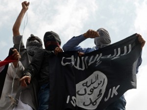 Kashmiri demonstrators hold up a flag of the Islamic State of Iraq and the Levant (ISIL) during a demonstration against Israeli military operations in Gaza, in downtown Srinagar on July 18, 2014. The death toll in Gaza hit 265 as Israel pressed a ground offensive on the 11th day of an assault aimed at stamping out rocket fire, medics said. AFP PHOTO/Tauseef MUSTAFA        (Photo credit should read TAUSEEF MUSTAFA/AFP/Getty Images)