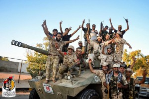 U.S.-backed forces celebrate re-taking Sirte, Libya from the Islamic State group Thursday, Aug. 11, 2016. They have liberated "70 percent" of the city of Sirte, the Islamic State group's last bastion in the North African country, after seizing several strategic locations over the past 24 hours under the cover of U.S. airstrikes, a Libyan official said Thursday. (Albinyan Al Marsous Operation Media Center via AP)