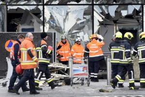 Broken windows of the terminal at Brussels airport are seen during a ceremony following bomb attacks in Brussels in Zaventem, Belgium, March 23, 2016. REUTERS/Yorick Jansens/Pool