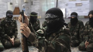 A female member of the Ahbab Al-Mustafa Battalion assembles a rifle during military training in a mosque in the Seif El Dawla neighbourhood in Aleppo June 24, 2013. Picture taken June 24, 2013. REUTERS/Muzaffar Salman (SYRIA - Tags: CONFLICT CIVIL UNREST MILITARY) - RTX1105Q