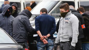 Belgian plainclothes police apprehend a youth in the Brussels district of Molenbeek, Belgium, April 2, 2016.   REUTERS/Yves Herman